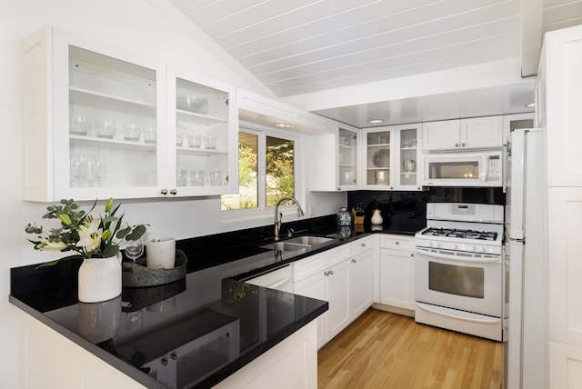 kitchen with sink, vaulted ceiling, light hardwood / wood-style flooring, white appliances, and white cabinets