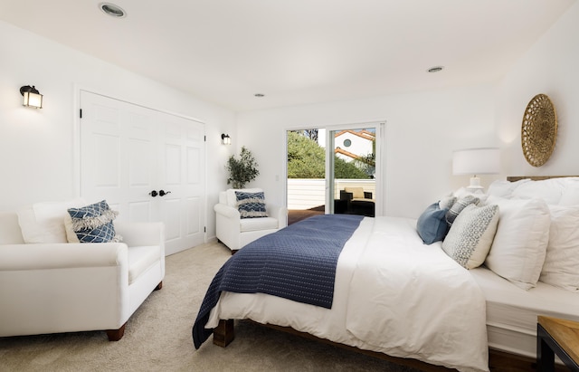 carpeted bedroom with access to exterior and a closet