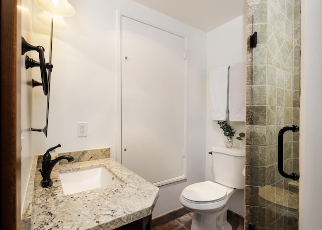 bathroom with vanity, toilet, and a shower