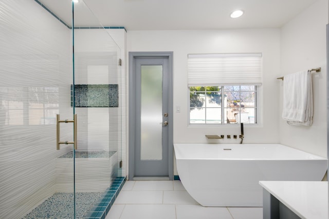 bathroom featuring tile patterned floors, independent shower and bath, and vanity