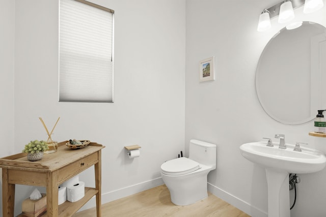 bathroom with hardwood / wood-style flooring, sink, and toilet