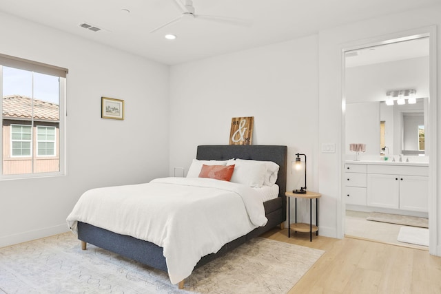 bedroom with ceiling fan, sink, connected bathroom, and light hardwood / wood-style floors