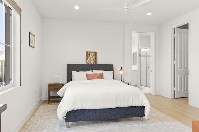 bedroom with ceiling fan, connected bathroom, and light hardwood / wood-style floors