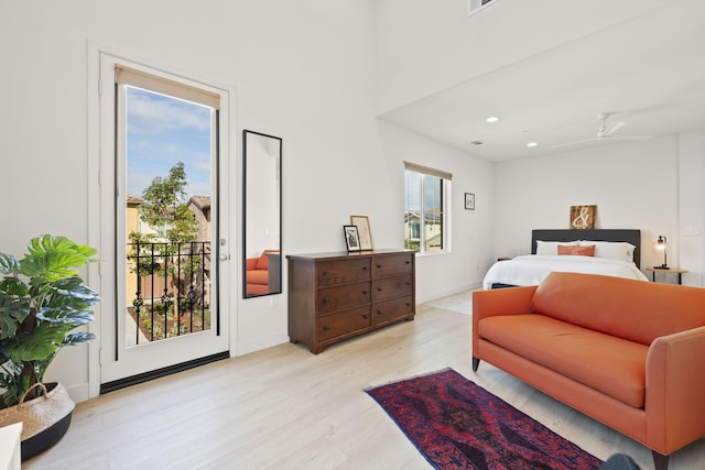 bedroom with access to exterior and light hardwood / wood-style floors