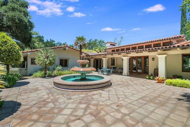 rear view of house featuring a patio area and french doors