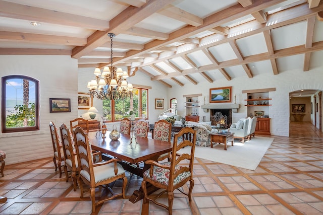 dining room featuring a notable chandelier and vaulted ceiling with beams