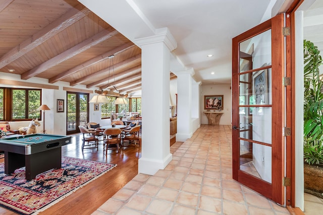 rec room with lofted ceiling with beams, wooden ceiling, french doors, and ornate columns