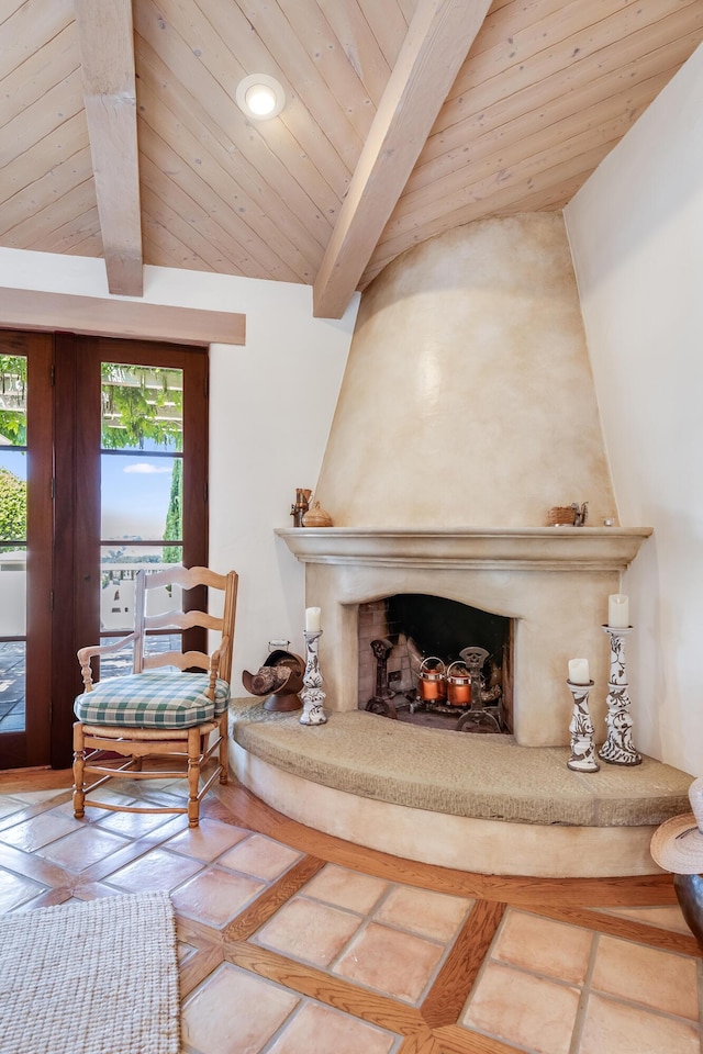 living area featuring vaulted ceiling with beams, a fireplace, and wood ceiling