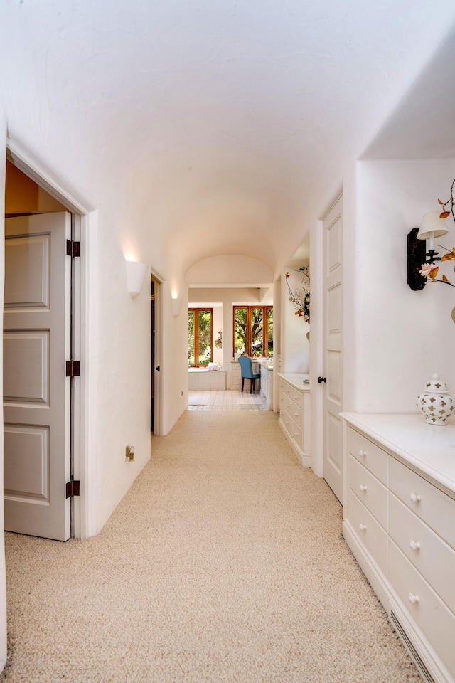 hallway with light colored carpet