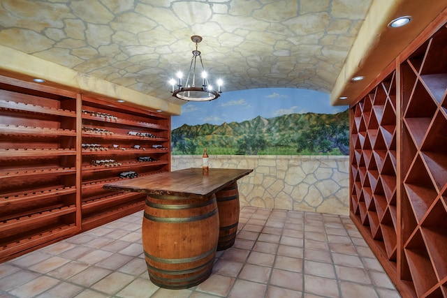 wine cellar featuring lofted ceiling and a notable chandelier