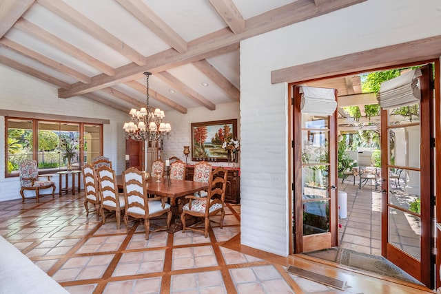 dining area featuring lofted ceiling with beams, french doors, and a chandelier