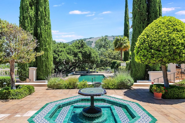 exterior space featuring a mountain view and a patio