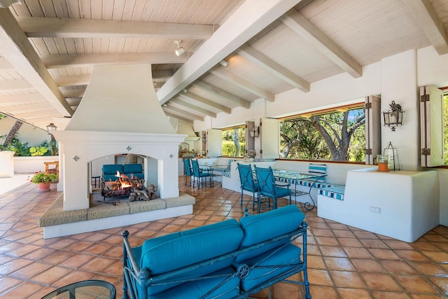 view of patio featuring an outdoor living space with a fireplace and exterior bar