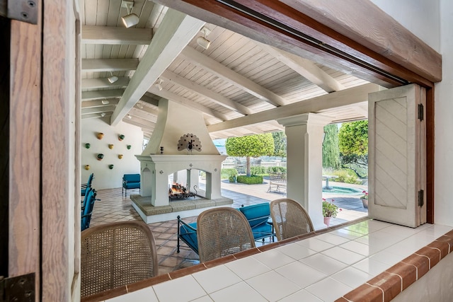 interior space with a bar, a multi sided fireplace, and a gazebo