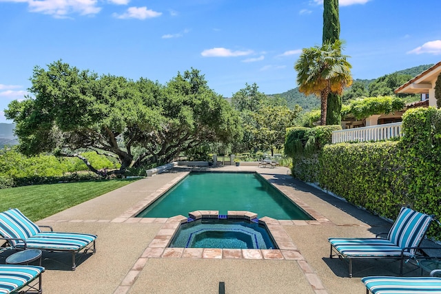 view of swimming pool with a patio area and an in ground hot tub