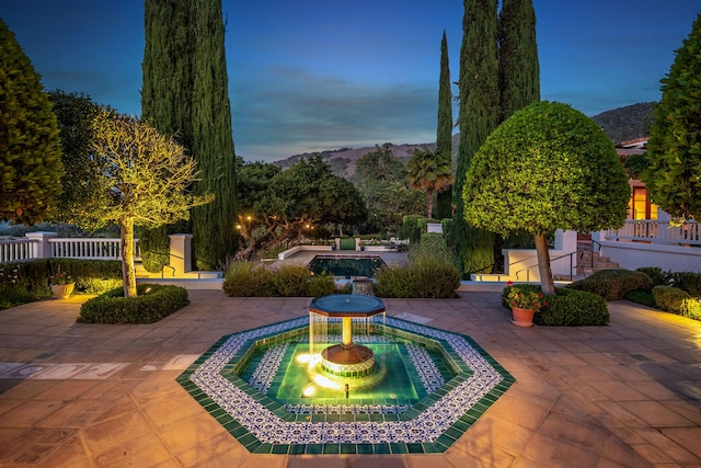 view of community featuring a mountain view and a patio