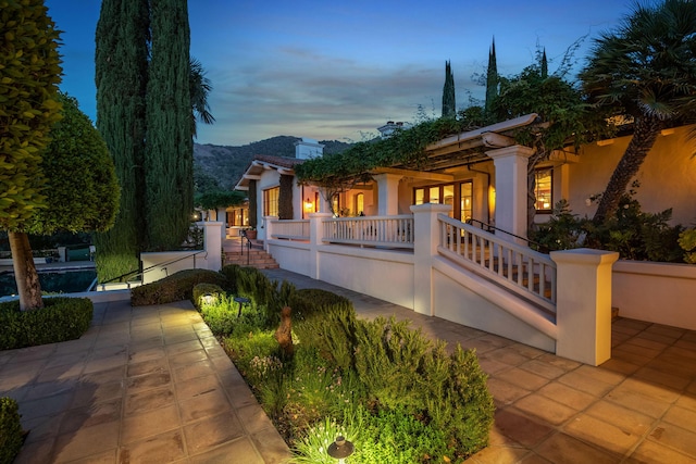 view of front facade with french doors and a patio