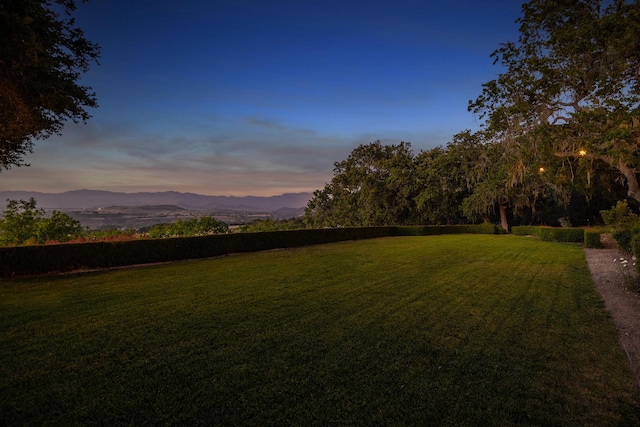 yard at dusk with a mountain view