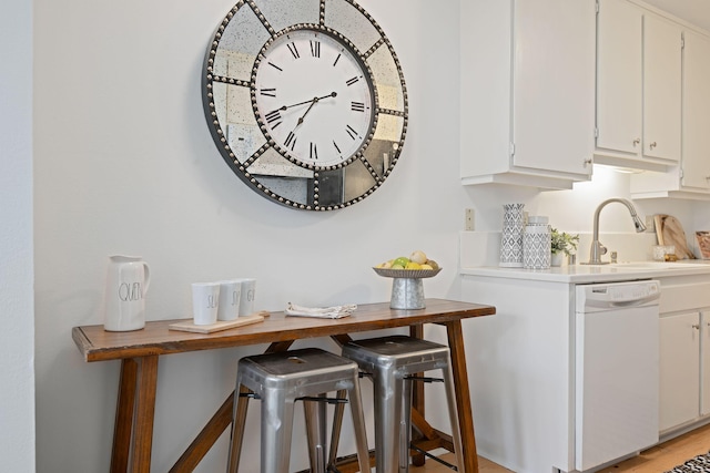 bar featuring sink, white cabinets, and white dishwasher