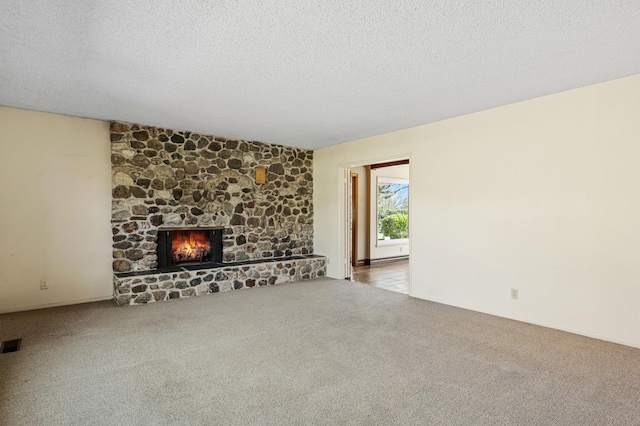2385 Janin Pl, Solvang, CA 93463 - unfurnished living room featuring a stone fireplace, carpet floors, and a textured ceiling