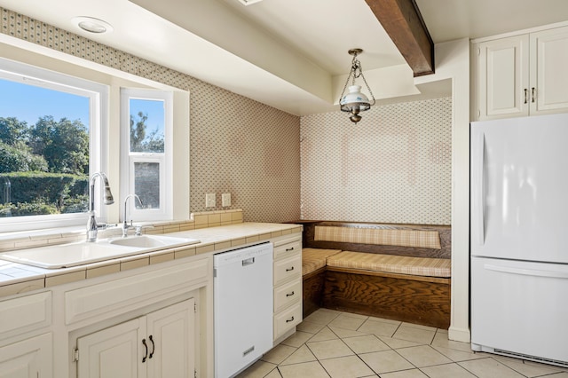 2385 Janin Pl, Solvang, CA 93463 - kitchen with sink, white appliances, white cabinetry, hanging light fixtures, and tile countertops