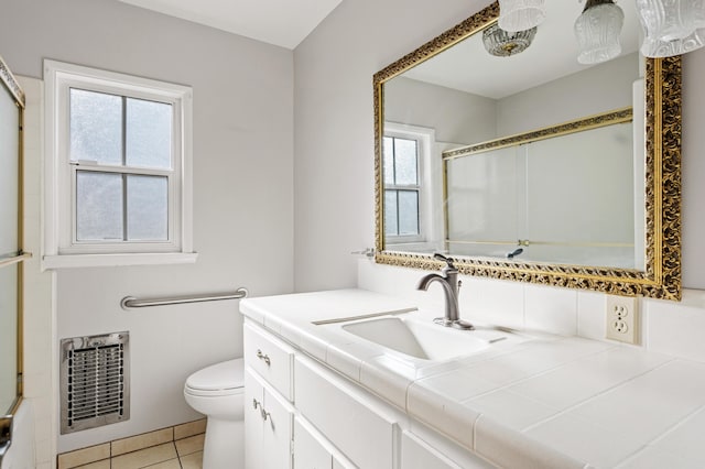 2385 Janin Pl, Solvang, CA 93463 - bathroom with heating unit, vanity, an enclosed shower, toilet, and tile patterned floors