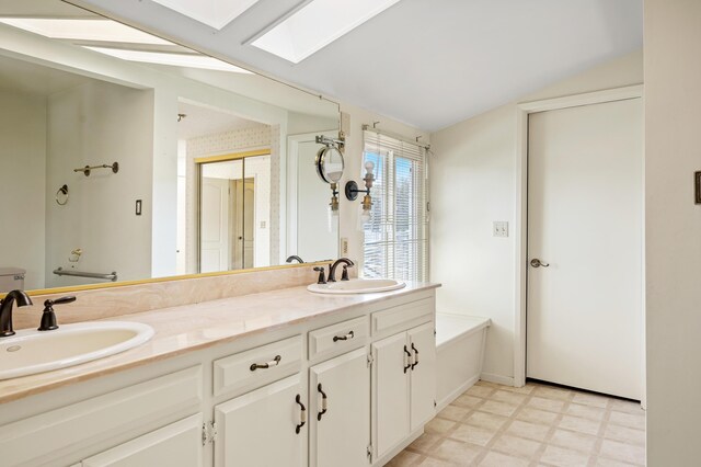 2385 Janin Pl, Solvang, CA 93463 - bathroom featuring vanity, lofted ceiling with skylight, and a bathing tub