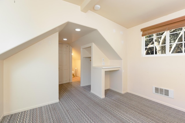 bonus room featuring lofted ceiling with beams and carpet floors