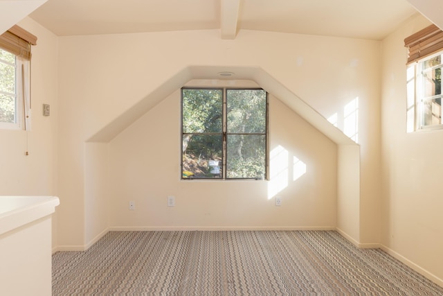 bonus room featuring carpet and vaulted ceiling with beams