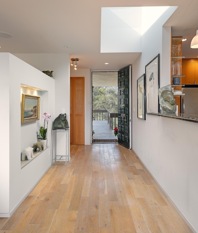 hall with light hardwood / wood-style flooring