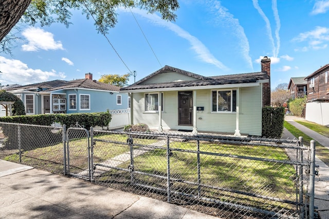 bungalow-style home with a front yard