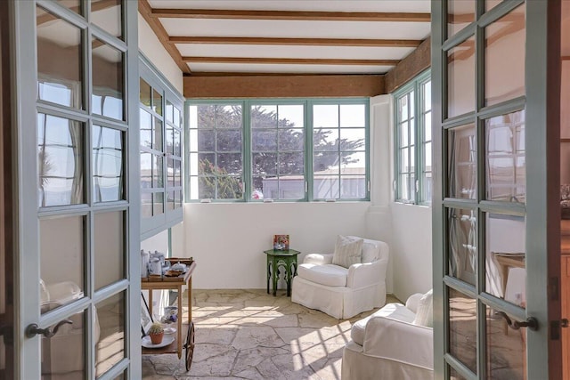 sunroom / solarium featuring french doors and beam ceiling