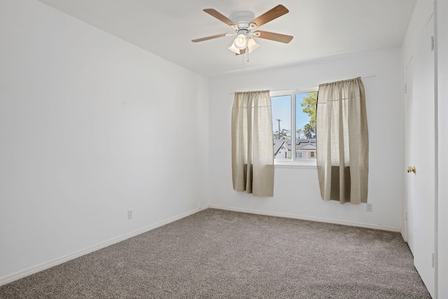 empty room featuring carpet floors, baseboards, and a ceiling fan