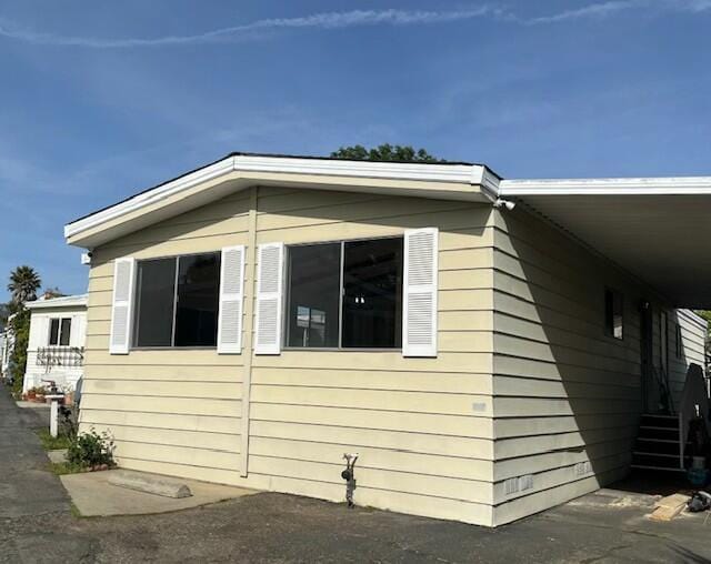 view of home's exterior featuring a carport