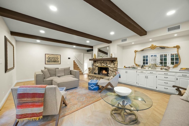 living area featuring baseboards, a fireplace, visible vents, and recessed lighting