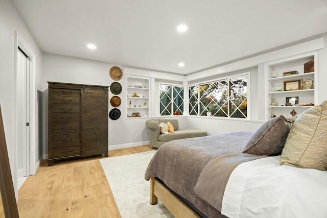 bedroom featuring light wood-type flooring, baseboards, and recessed lighting