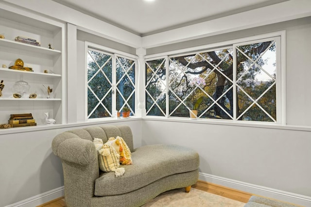 sitting room with wood finished floors and baseboards