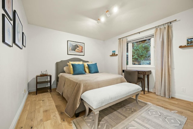 bedroom featuring light wood-style flooring and baseboards
