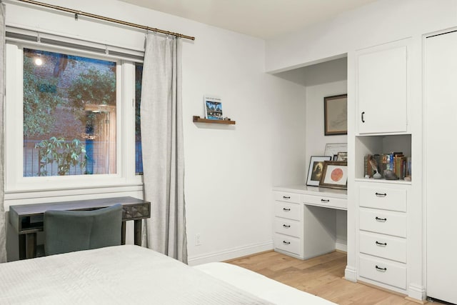 bedroom featuring baseboards and light wood-style flooring