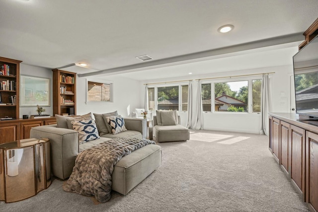 living room with light colored carpet, a wealth of natural light, visible vents, and recessed lighting
