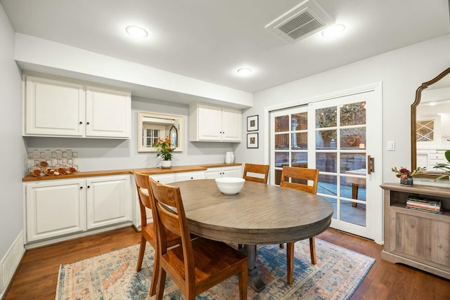 dining space featuring visible vents and dark wood finished floors
