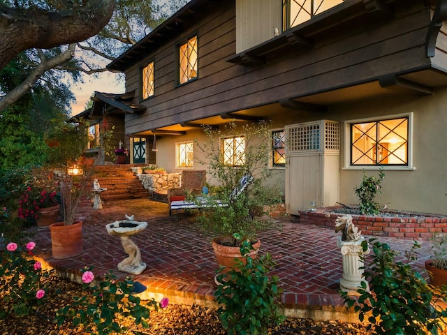 back of house with a patio and stucco siding