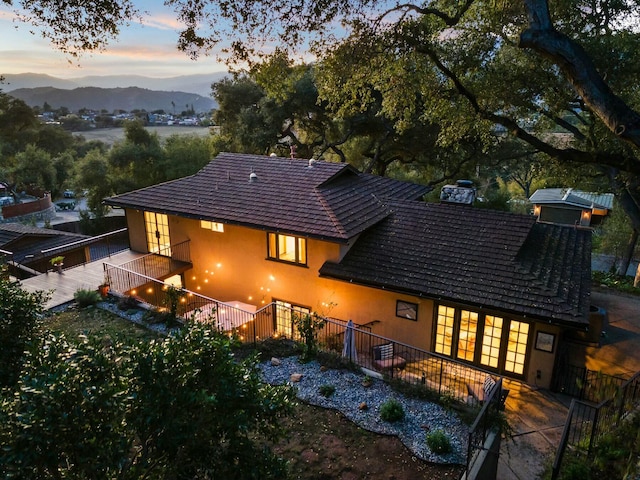 back of house featuring a mountain view and stucco siding