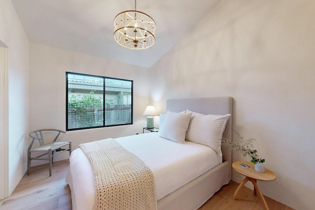 670 Santa Lucia Ave, Los Osos, CA 93402 - bedroom featuring lofted ceiling, light wood-type flooring, and a chandelier