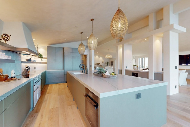 670 Santa Lucia Ave, Los Osos, CA 93402 - kitchen with light wood-type flooring, light countertops, island exhaust hood, and a large island