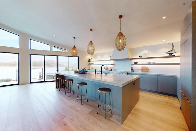 670 Santa Lucia Ave, Los Osos, CA 93402 - kitchen with a breakfast bar, a large island, hanging light fixtures, a sink, and modern cabinets