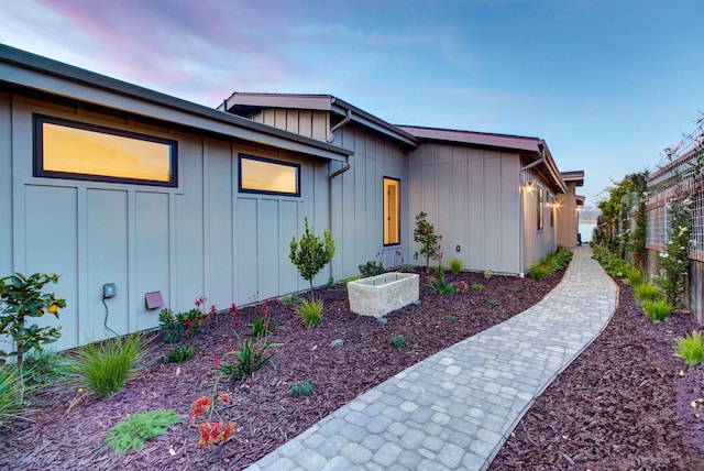 670 Santa Lucia Ave, Los Osos, CA 93402 - property exterior at dusk featuring fence and board and batten siding
