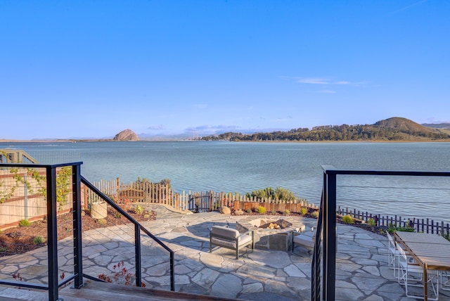 670 Santa Lucia Ave, Los Osos, CA 93402 - property view of water with an outdoor fire pit, fence, and a mountain view