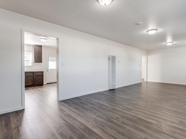 empty room with dark wood-type flooring