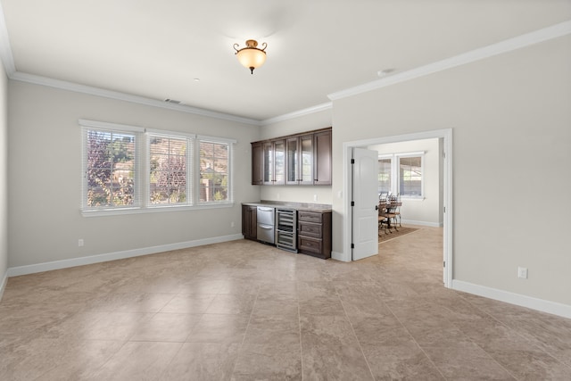 interior space with bar and crown molding